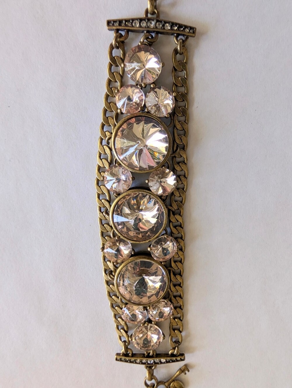 Fossil chunky gold bracelet with large clear crystals and a key charm